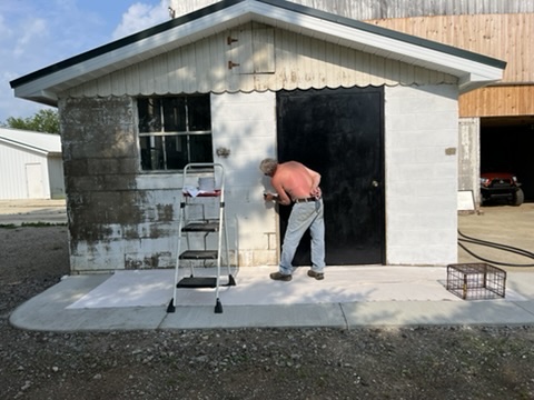 Jim is hard at work repainting the honey house